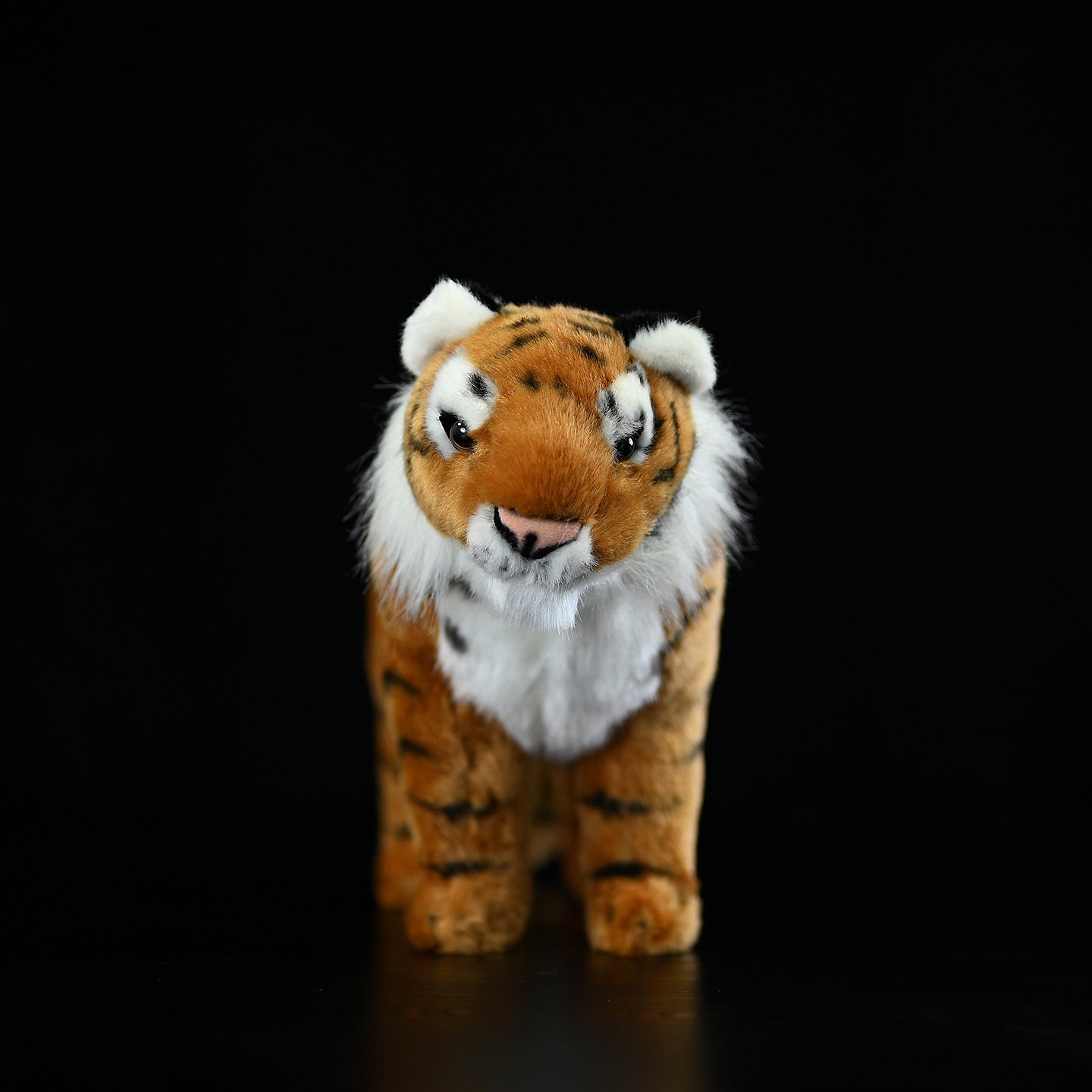 Front view of a lifelike tiger plush toy, showcasing its detailed face and realistic design