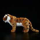 Side profile of a soft tiger plush toy, highlighting its striking stripes and natural pose