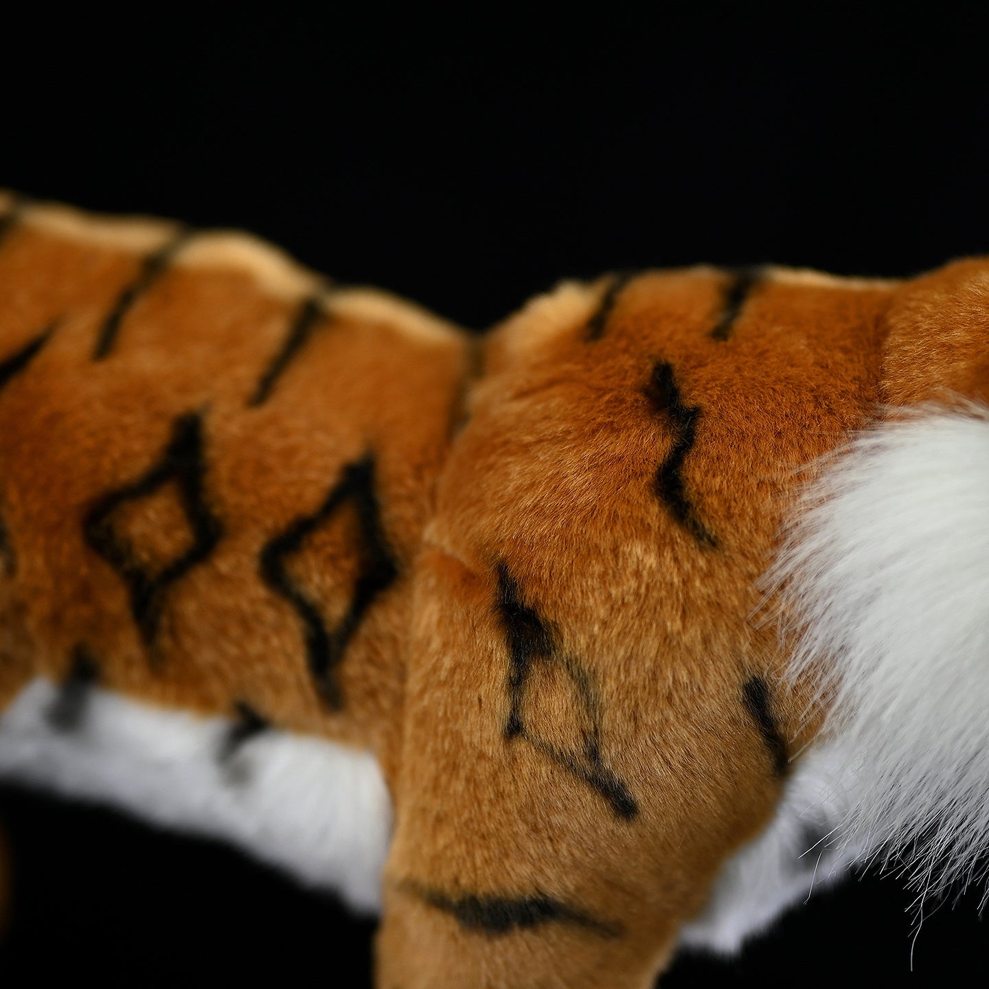 Detailed shot of the tiger plush toy's body, showcasing its realistic stripes and soft texture
