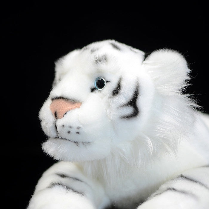 Close-up of a white tiger plush face, featuring striking blue eyes and soft fur for animal lovers