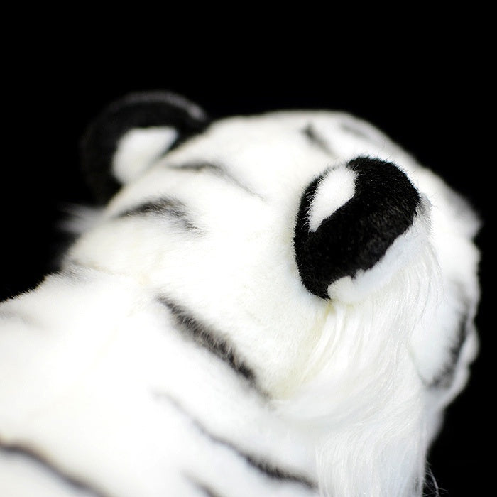 Detailed view of the soft ears and stripes of a white tiger stuffed animal, great for tiger enthusiasts