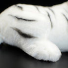 Realistic tail detail of a white tiger stuffed animal with lifelike fur texture for wildlife fans
