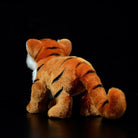 Back view of a tiger cub plush toy, highlighting its soft fur and detailed striped tail