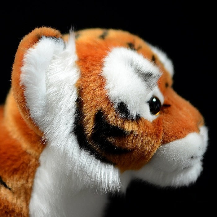 Side close-up of a tiger cub plush toy's face, showcasing realistic stripes and soft, fluffy ears