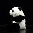Side profile of a realistic giant panda plush toy, highlighting its thick fur and cuddly design
