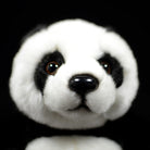 Close-up of a giant panda plush toy's face, featuring lifelike details and adorable eyes