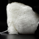 Back close-up of the giant panda plush toy, showing its fluffy texture and realistic design