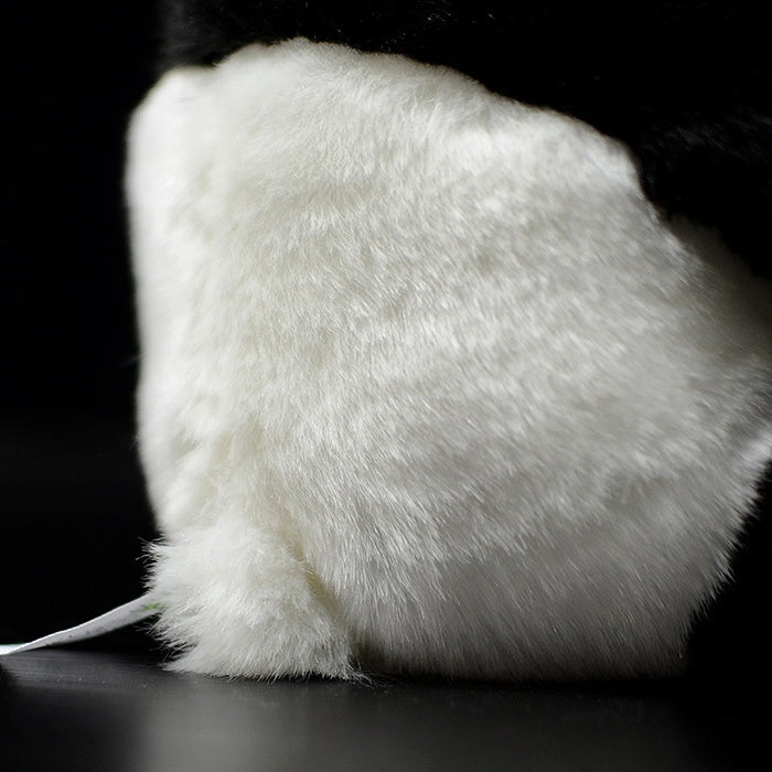 Back close-up of the giant panda plush toy, showing its fluffy texture and realistic design