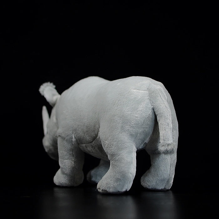 Rear view of SoftDaysLab white rhinoceros stuffed animal, featuring realistic tail and soft texture