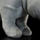 Close-up of a white rhino plush toy's feet, showcasing its soft and lifelike design