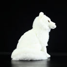 Side view of a cuddly Arctic fox plush toy, showcasing its realistic design and soft texture