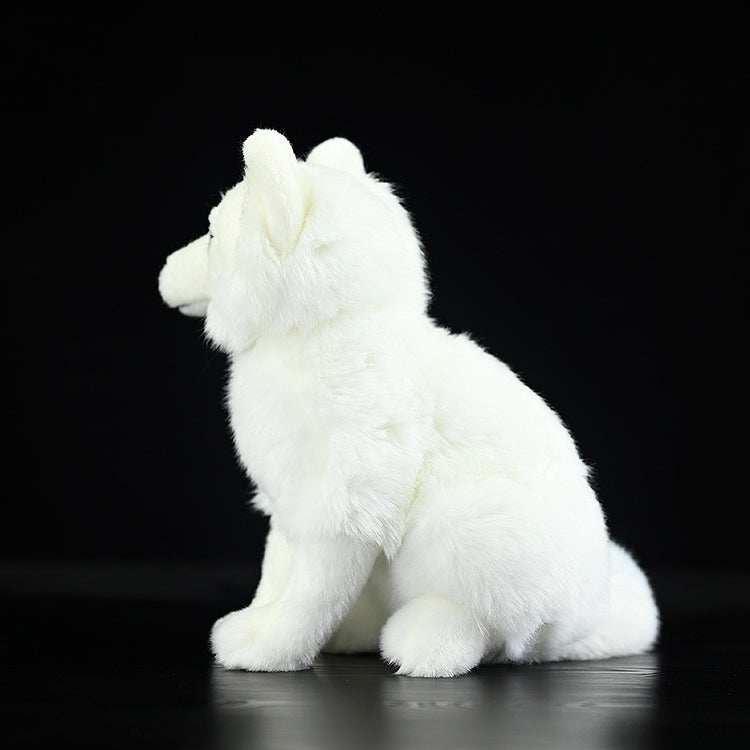 Back angled view of an Arctic fox stuffed animal, highlighting its fluffy fur and lifelike posture