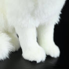 Zoomed-in view of the Arctic fox plush toy's soft paws and fluffy fur texture