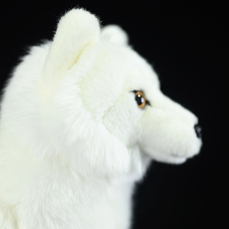 Profile view of the Arctic fox plush toy, featuring its realistic head and ear details