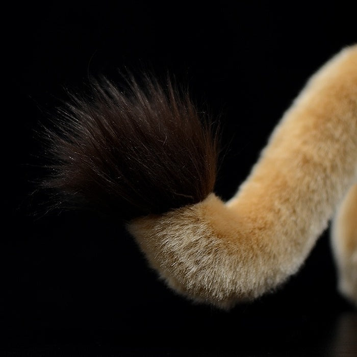Close-up of the lion plush toy’s tail with a fluffy tuft, offering charming attention to detail