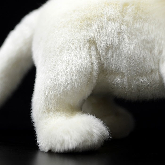 Close-up of the soft fur and detailed paw of the white lion plush toy for collectors