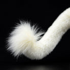 Tail close-up of the white lion plush toy with fluffy and realistic detailing