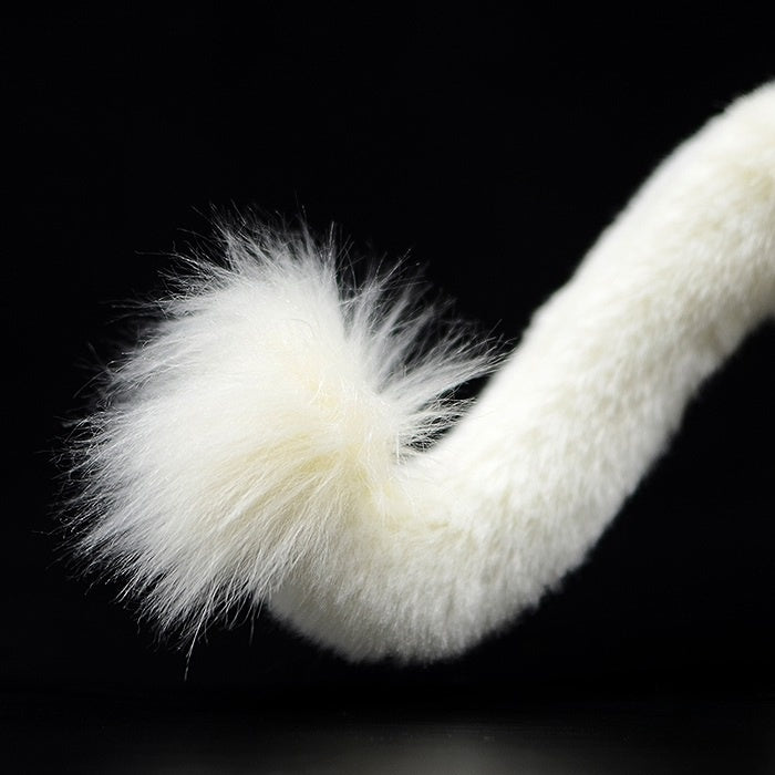 Tail close-up of the white lion plush toy with fluffy and realistic detailing