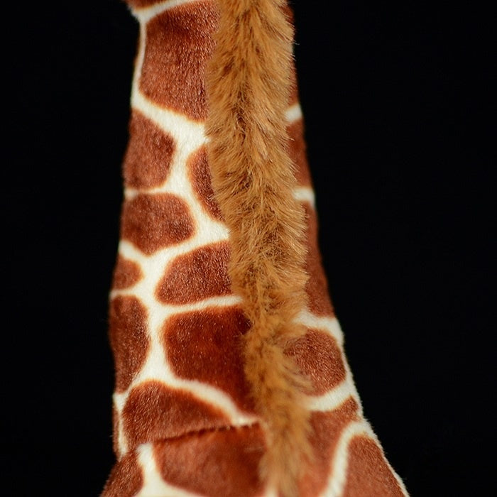 Detailed view of the plush giraffe's neck, showing its realistic fur and intricate patterning