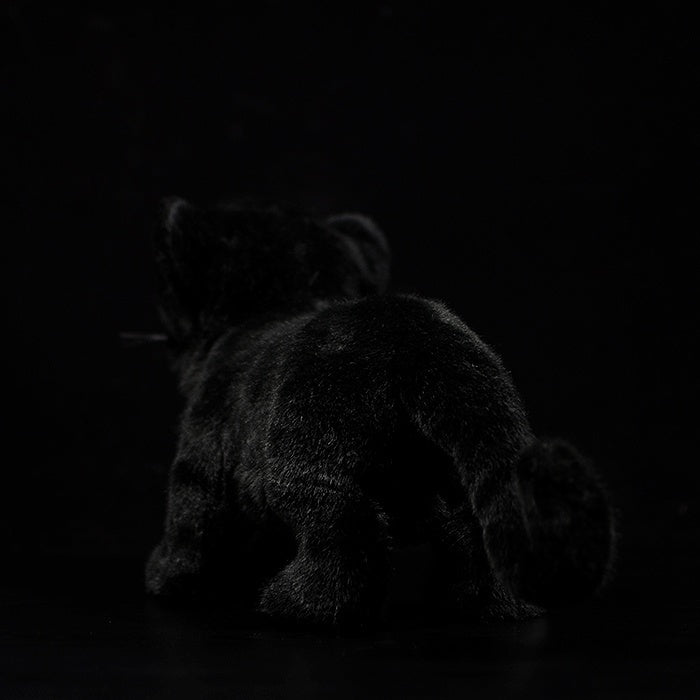 Back view of a black panther cub plush showcasing its realistic fur texture and playful design