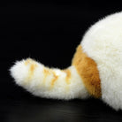 Fluffy striped tail of an orange and white Exotic Shorthair plush cat, a charming addition to any plush collection