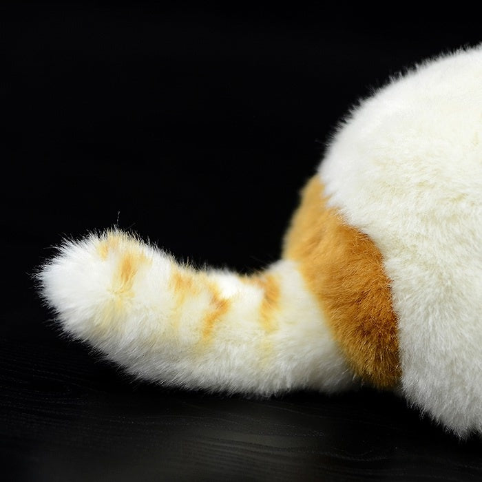 Fluffy striped tail of an orange and white Exotic Shorthair plush cat, a charming addition to any plush collection