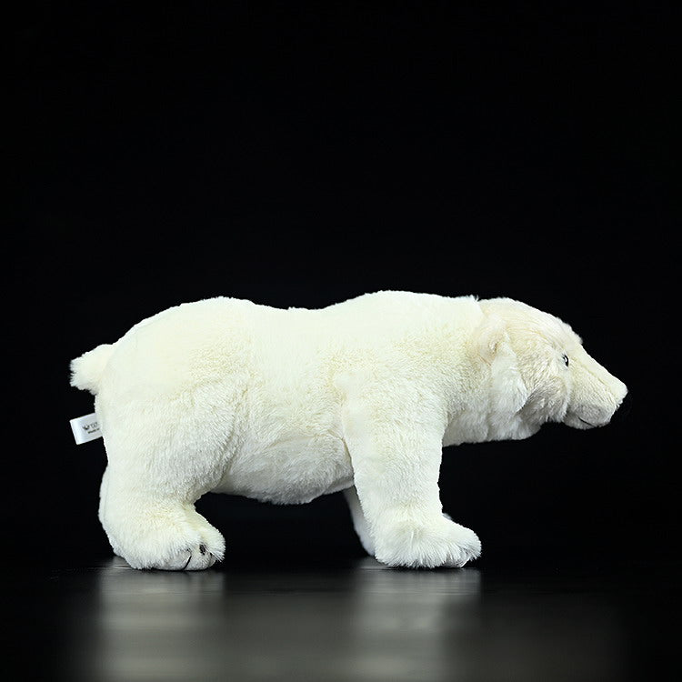 Side view of a realistic polar bear plush toy, featuring soft white fur and lifelike Arctic animal design