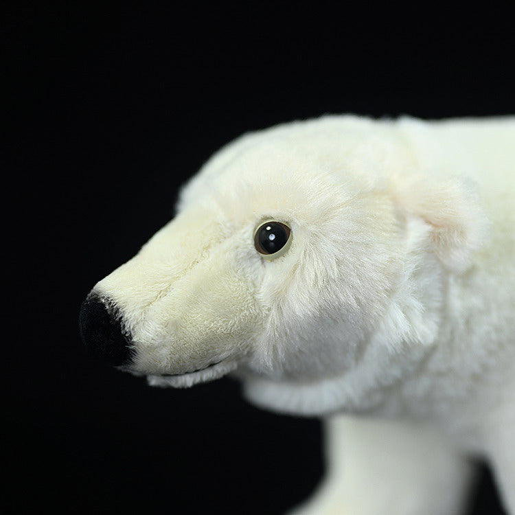 Close-up of the polar bear plush toy's face, showing lifelike eyes, nose, and soft white fur
