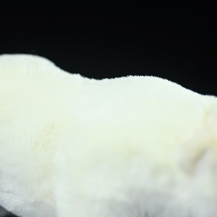 Detailed shot of the polar bear plush toy's back, showcasing the smooth and fluffy white fur