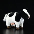 Realistic plush Holstein cow toy with black-and-white markings, perfect for animal lovers and collectors