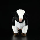 Front view of a soft Holstein cow plush featuring a lifelike black-and-white design and detail