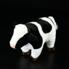 Top view of a Holstein cow plush toy with soft fabric and authentic markings for collectors or kids