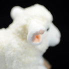 Detailed side view of the sheep plush's ear, featuring its realistic design and soft fabric
