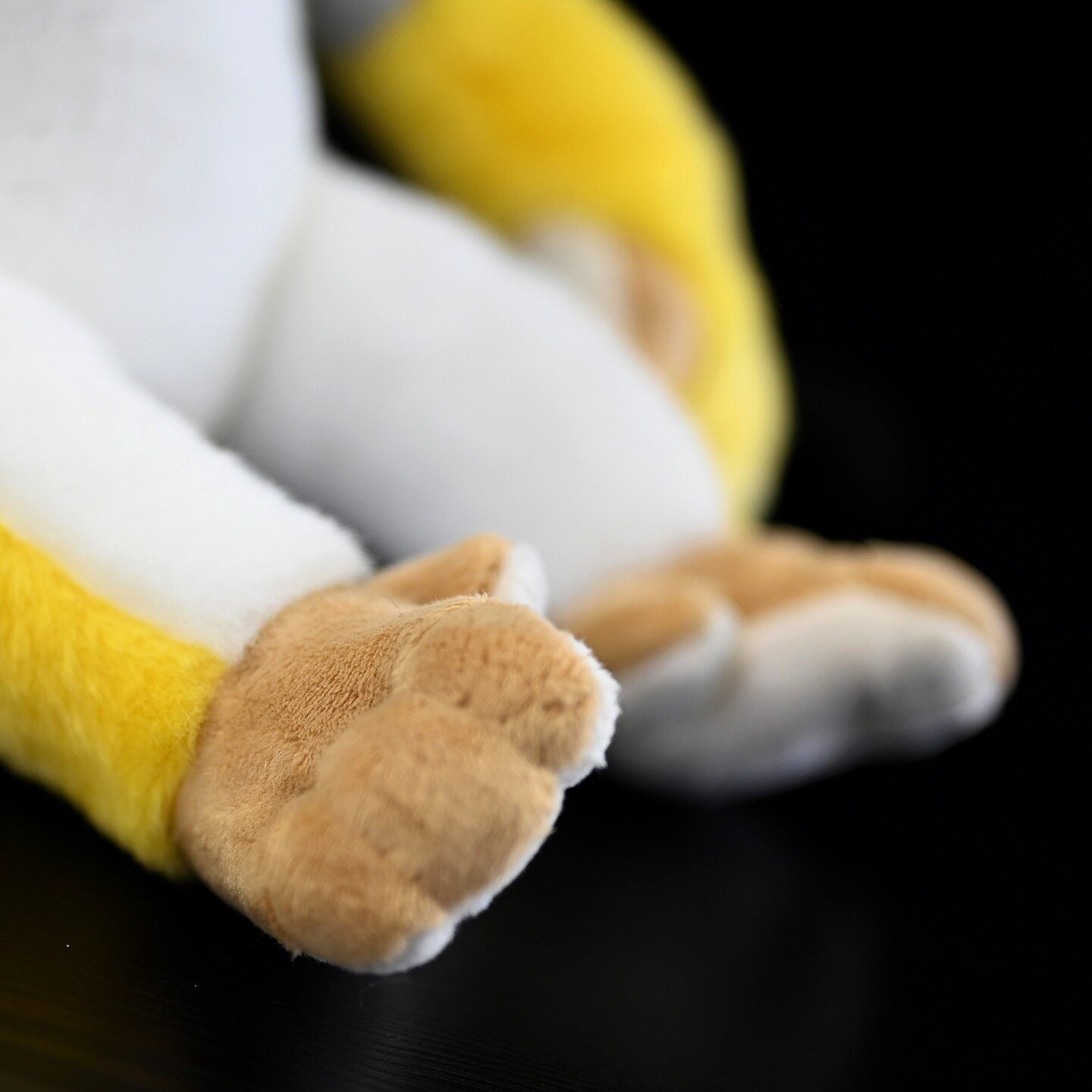 Foot detail of Common Squirrel Monkey plush, highlighting soft, realistic textures for added charm