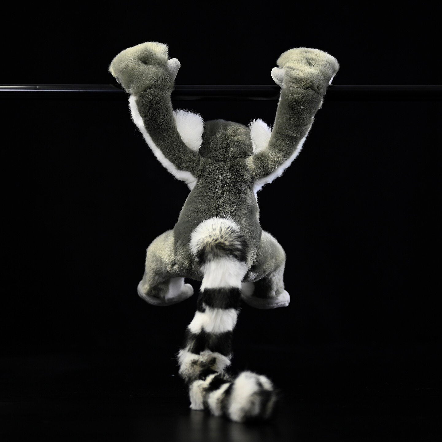 Back view of the Ring-tailed Lemur plush hanging, showing iconic stripy tail and soft fur