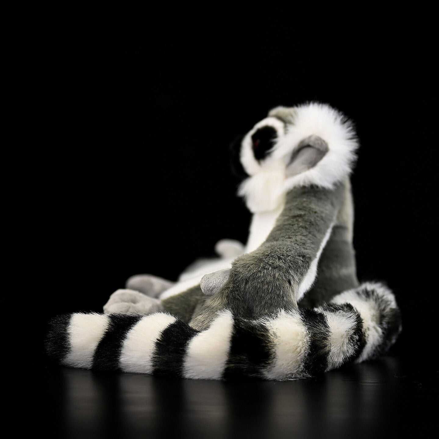 Side view of Ring-tailed Lemur plush, highlighting its lifelike stripey tail and soft fur