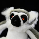 Close-up face of the Ring-tailed Lemur plush, with captivating red eyes and vibrant design