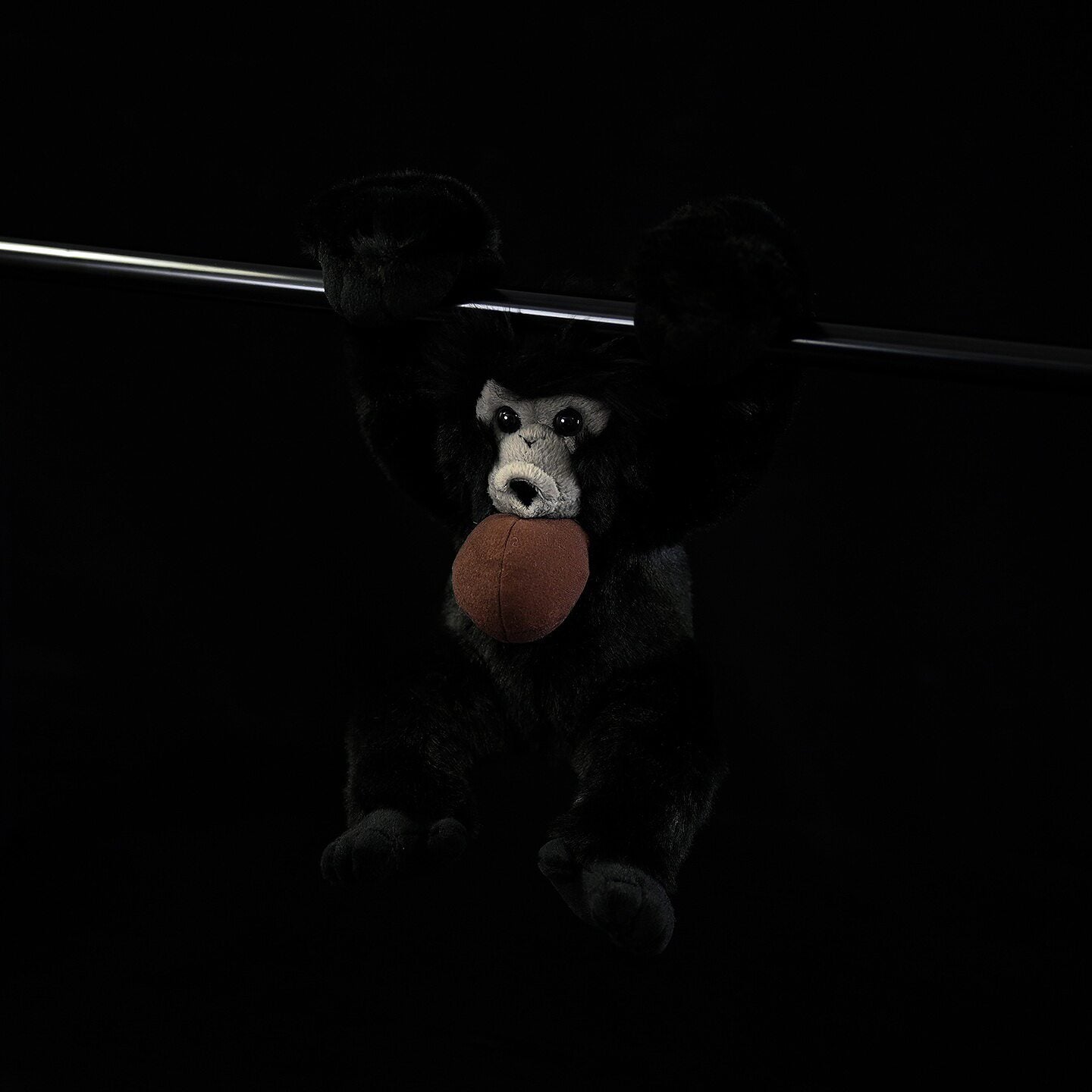 Lifelike Siamang Gibbon plush hanging pose, featuring soft black fur and expressive design