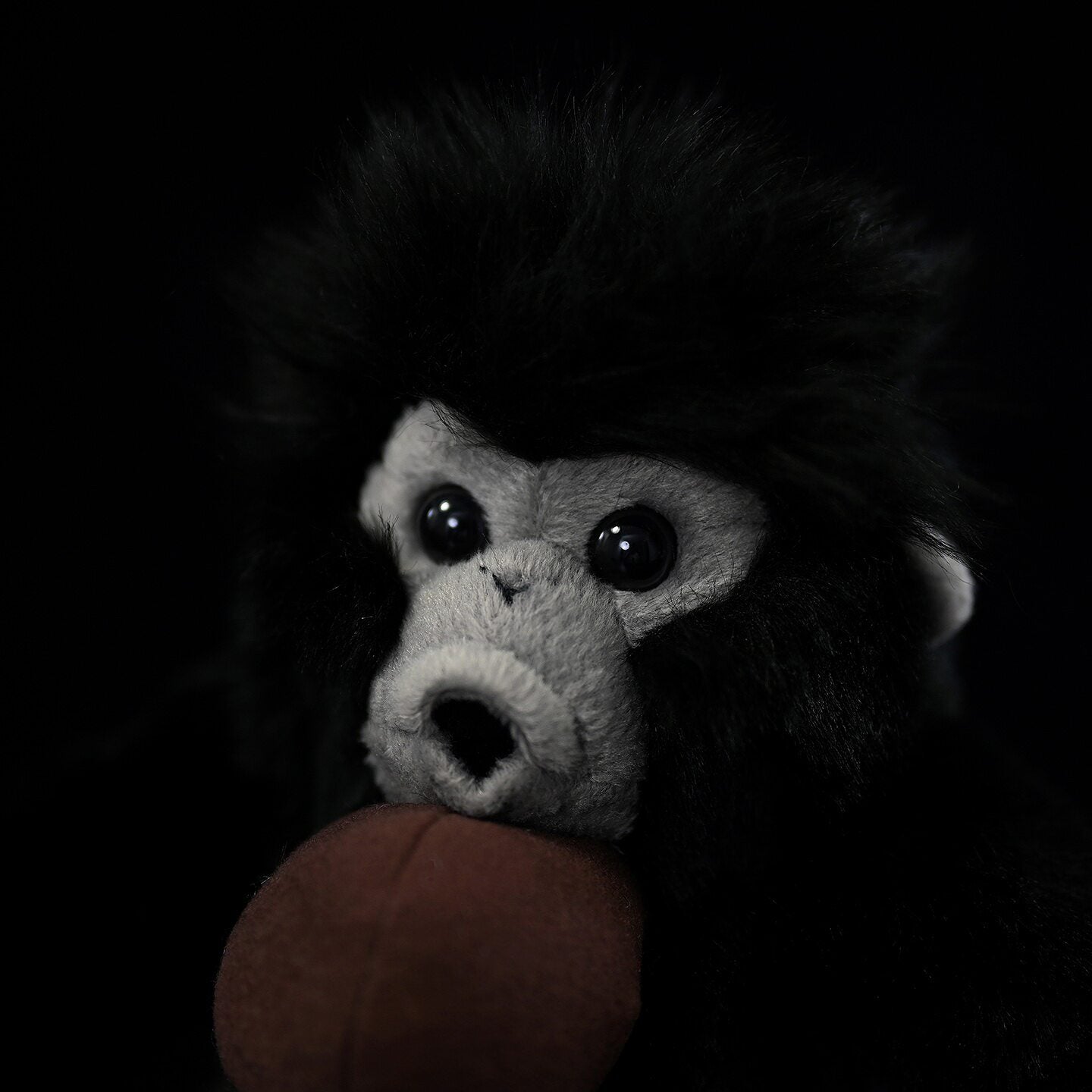 Close-up of realistic Siamang Gibbon plush face with intricate details and soulful eyes
