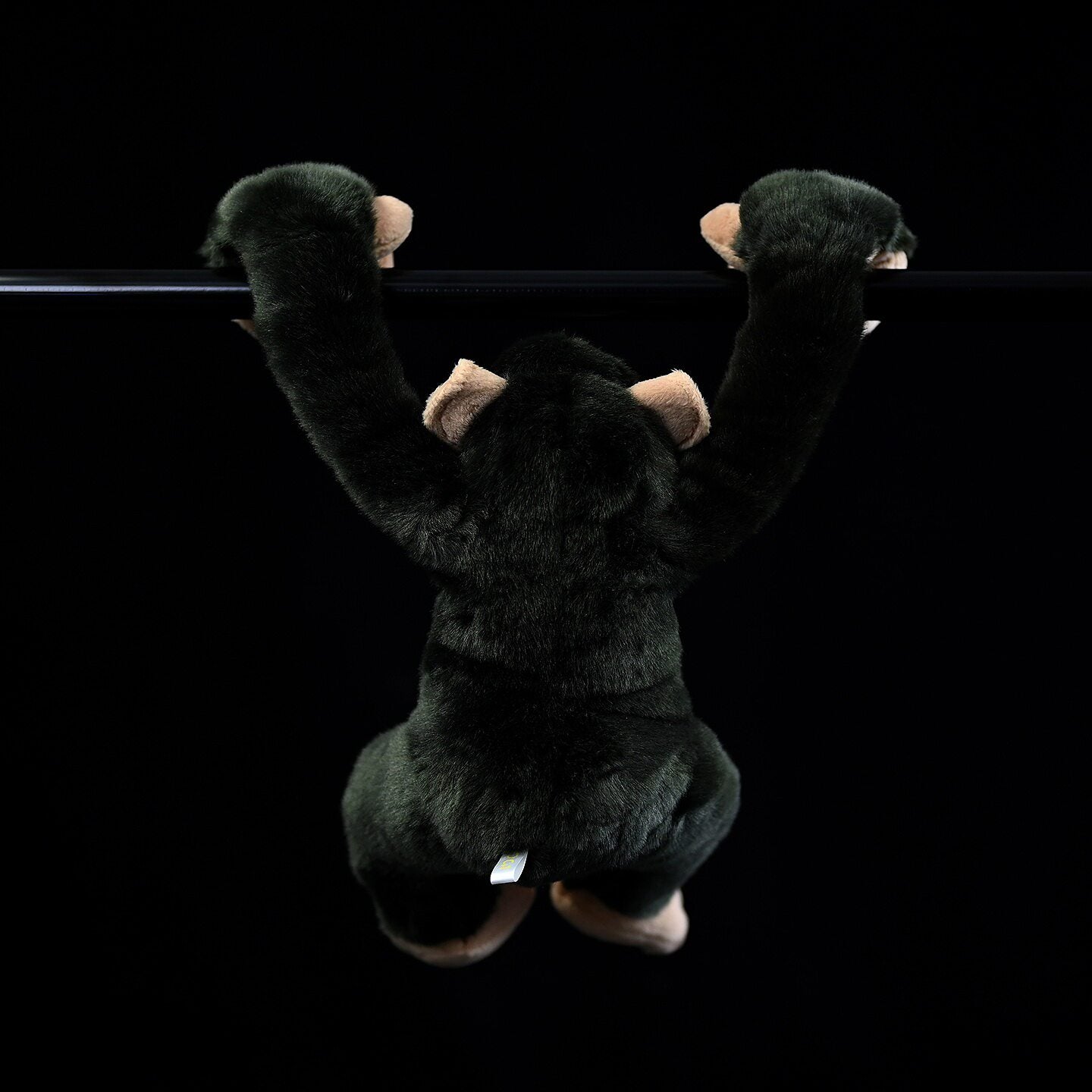 Back view of hanging chimpanzee plush, showcasing soft fur and crafted details for a natural look