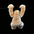 Back view of lifelike gibbon plush hanging from a bar, lifelike SoftDaysLab gibbon stuffed animal