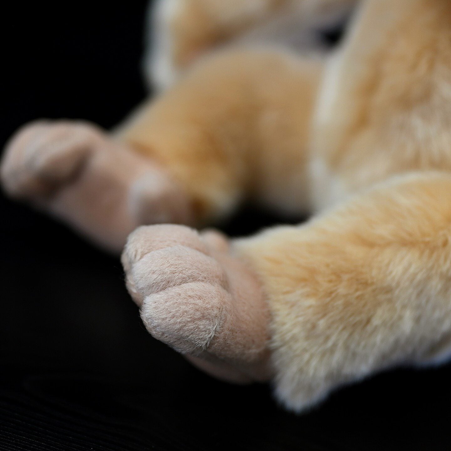 Close-up of hanging gibbon plush feet, SoftDaysLab detailed gibbon toy resembling real animal features