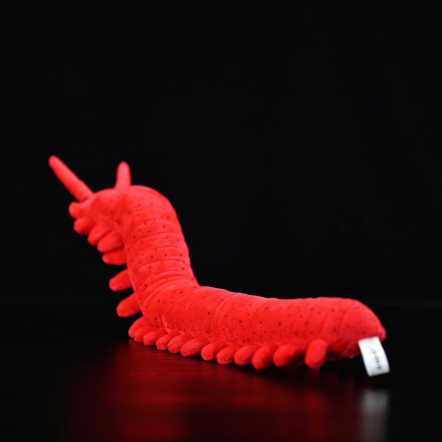 Back view of the velvet worm plush toy, displaying its soft segmented body and realistic leg details by SoftDaysLab