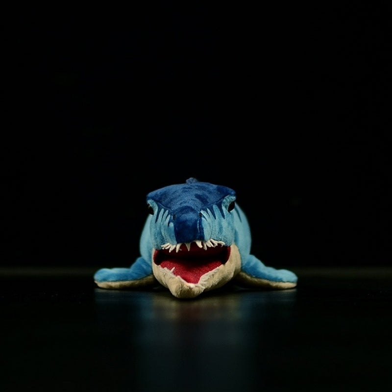 Front view of a Mosasaurus stuffed toy showing open jaws with sharp teeth and red mouth lining