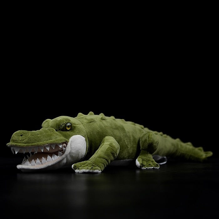 Realistic alligator plush toy lying on its side, showcasing lifelike details and soft green texture