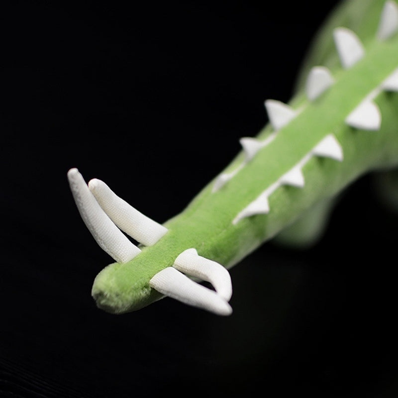 Tail-focused view of Huayangosaurus dinosaur plush toy with soft texture and characteristic spikes