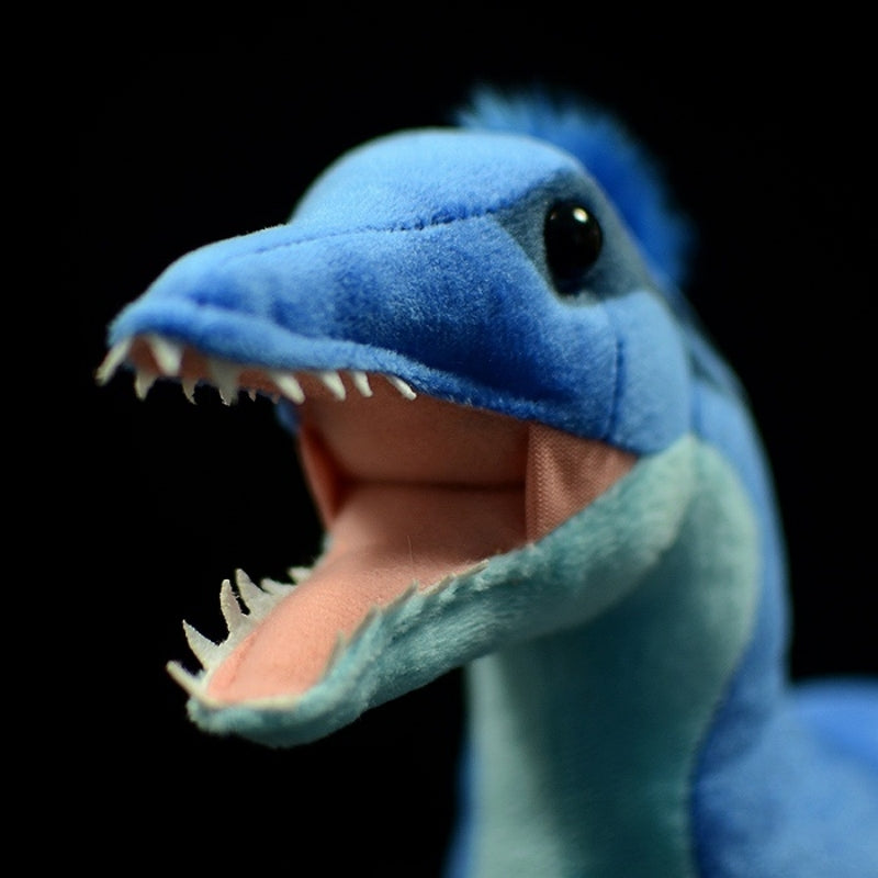 Close-up of Microraptor dinosaur plush toy’s head displaying sharp teeth and charming eyes