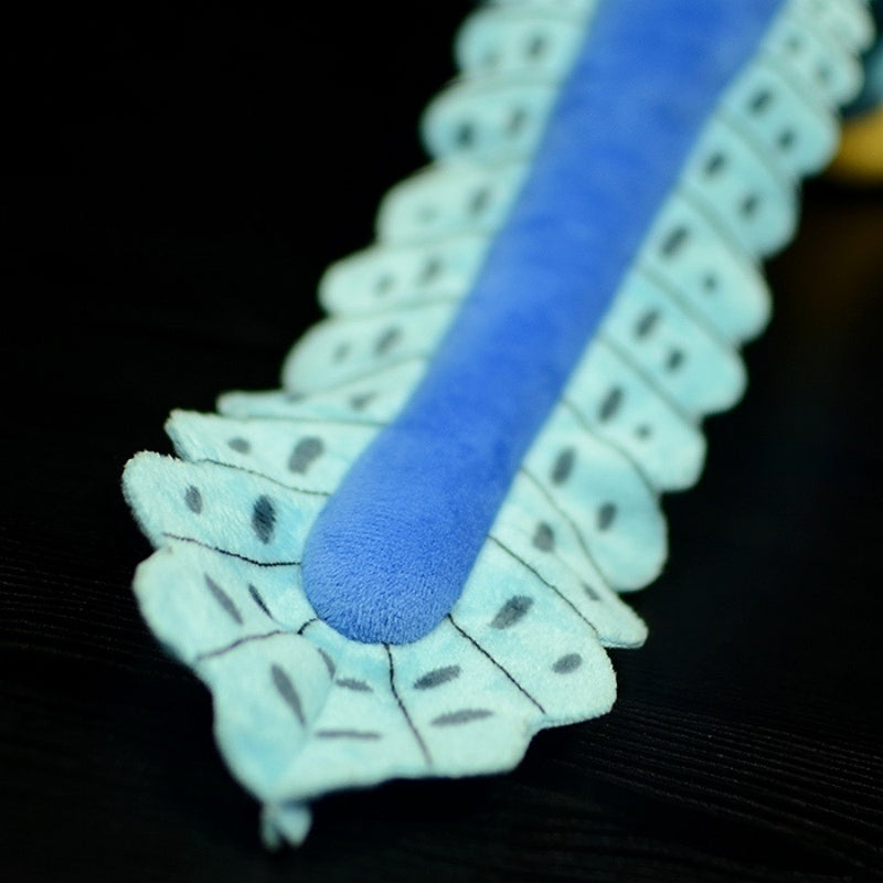 Tail close-up of Microraptor dinosaur plush toy emphasizing its pattern and realistic design by SoftDaysLab