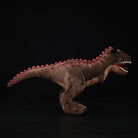 Side view of Carnotaurus Dinosaur Plush Toy with red spine detailing and realistic form