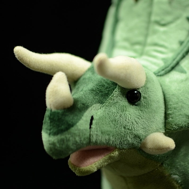 Close-up of Pentaceratops plush toy’s face, featuring detailed horns and expressive black eyes